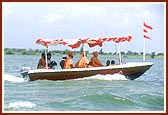 Swamishri with Thakorji and Ganeshji during the ritual five time circumambulatory boat ride in river Utavali 