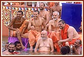 Swamishri in a jovial mood with sadhus after the Shri Ganesh visarjan ritual