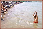 ... and blesses the joyous sadhus and devotees by showering them with water