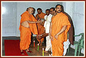 Swamishri emerges from his room and warmly greets the sadhus and devotees with folded hands and affectionate Jai Swaminarayan