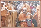 Swamishri patiently listens to details of the complex renovation plans and offers his guidance in the dusty environment