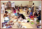 Devotees arranging the dishes for the Annakut display