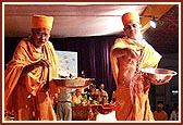 Viveksagar Swami and Siddheshvar Swami shower sanctified flower petals and rice grains on the account books