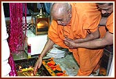 ... reverentially touches the holy charnarvind in Akshar Deri