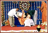 Dr. Bhimappa (former President of All India Medical Association) and his son present a gift to Swamishri