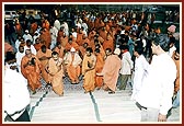 Swamishri is being carried up the mandir steps