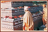 Out of respect Swamishri performs pradakshina and showers flowers on the mantra books