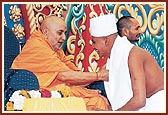 One-by-one, the newly-initiated sadhus, parshads and sadhaks receive blessings from Swamishri