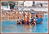 Swamishri prepares to take the ritual dip into the holy river