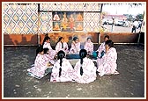 Young girls in the kutir offer grains in the yagna-pit while chanting the Swaminarayan mahamantra