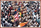 Women participate in the procession by carrying auspicious pots on their heads 