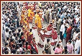 Women participate in the procession by carrying auspicious pots on their heads 