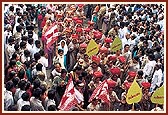 Women participate in the procession by carrying completed mantra notebooks on their heads as mark of reverence
