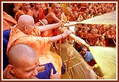 Swamishri finally sprays the colored water on all the sadhus