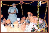 The Chief Minister holds aloft the sacred kalash during the Vedic ceremony