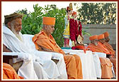 Swamishri and stage guests engrossed in prayer during the two minutes of silence observed in memory of the victims