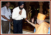 After the assembly Swamishri consoles and blesses relatives of the deceased victims inside the main monument