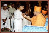 After the assembly Swamishri consoles and blesses relatives of the deceased victims inside the main monument