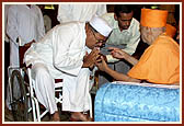 After the assembly Swamishri consoles and blesses relatives of the deceased victims inside the main monument