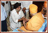 After the assembly Swamishri consoles and blesses relatives of the deceased victims inside the main monument