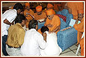 After the assembly Swamishri consoles and blesses relatives of the deceased victims inside the main monument