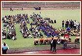 Balaks and balikas seated on the grounds of Alperton Sports Stadium before the start of the sports competitions