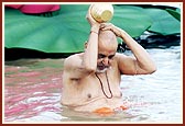 Swamishri bathing in the river Utavali. 