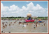 Sadhus and devotees take a holy dip in the river after the celebrations.