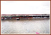 Devotees and sadhus seated on the banks of the river.