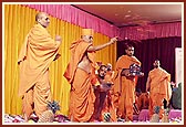 Swamishri showers sanctified flower petals on the account books  