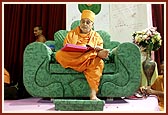   Swamishri writes his blessings in the account book