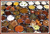 Sadhus arrange the cooked vegetables before Thakorji