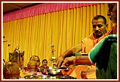 Panchamrut snanam: Swamishri first bathes the deities with milk