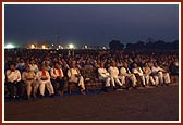 Devotees and sadhus engrossed in watching the enlightening and entertaining birthday celebration program