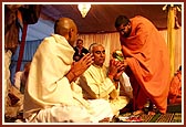 Youths and their parents perform the diksha rituals in the mahapuja