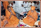 Swamishri chants dhun as part of the pratishtha rituals and prays for peace and happiness