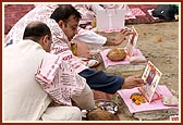 Devotees perform yagna rituals