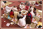 Devotees offer homa of ghee into the yagna kund