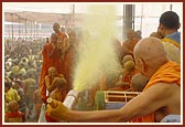 Swamishri happily directs a water spray on the sadhus