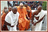 Swamishri being taken up the mandir steps