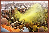 Swamishri drenches the joyous devotees in a shower of holy, colored water