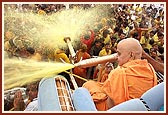 Swamishri directs the water spray on senior sadhus