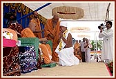 Swamishri initiates a Nepali youth