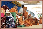 Swamishri gives diksha-mantra and initiates a parshad into the sadhu-fold