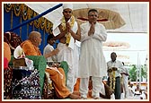 Then the parshad and his parent stand with folded hands besides Swamishri
