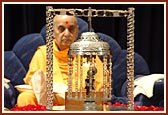 Swamishri's puja with Shri Harikrishna Maharaj placed on a decorated swing