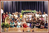 A group photo of the kishoris with the hindolo they prepared for Shri Harikrishna Maharaj and Swamishri