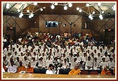 Kishores and kishoris seated in the auditorium