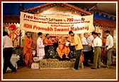 Pramukh Swami Maharaj presents the software to school representatives