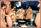 Sadhus serve in the kitchen preparing mealsfor pilgrims of Kumbh Mela